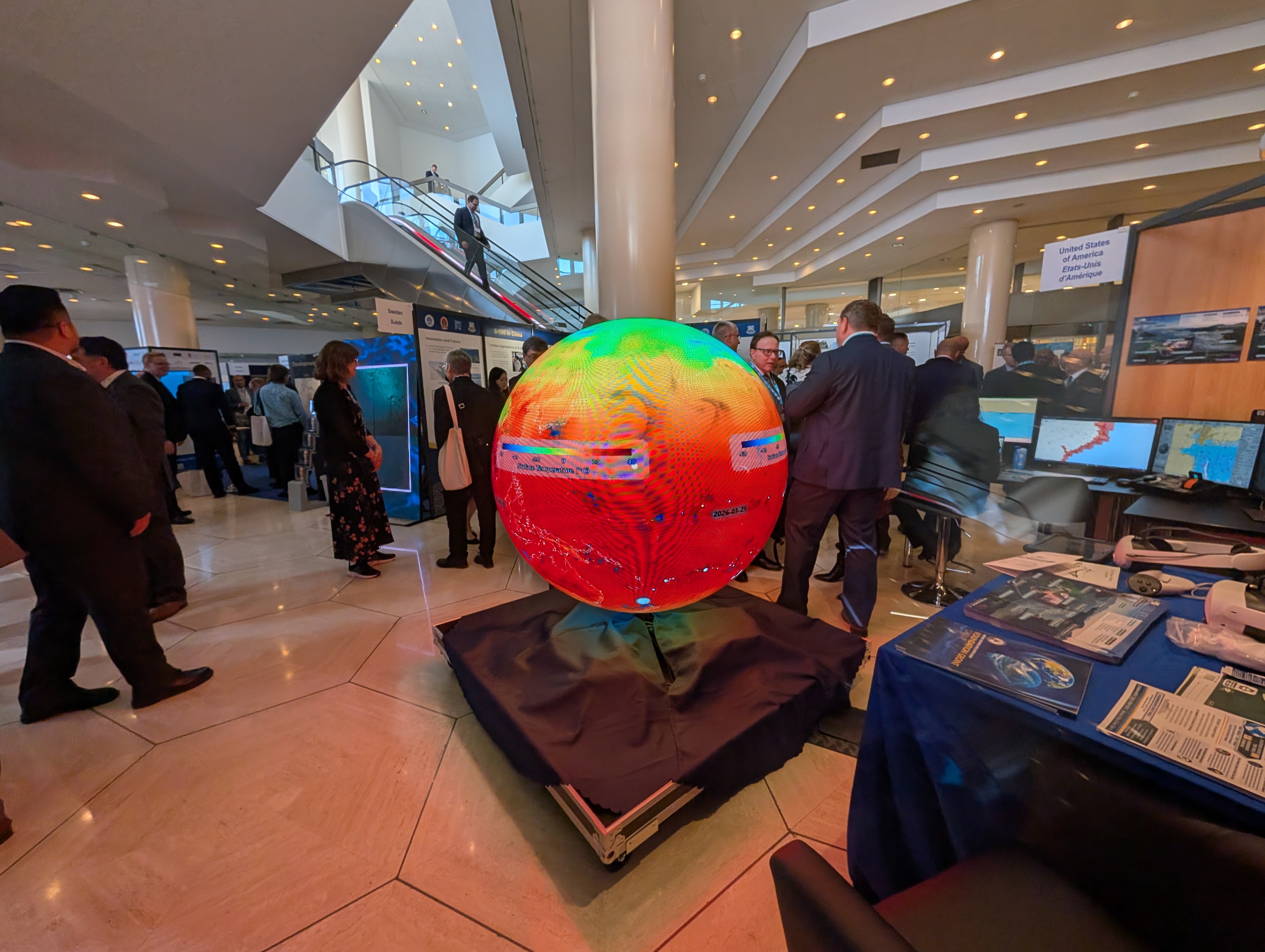 AYNI LED sphere surrounded by international delegates at the IHO Assembly
